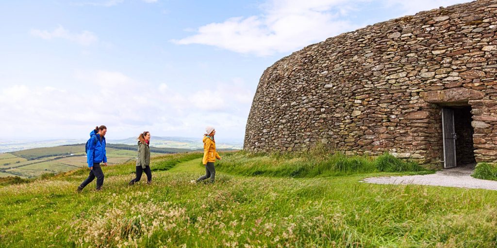 People walking towards ringfort entrance
