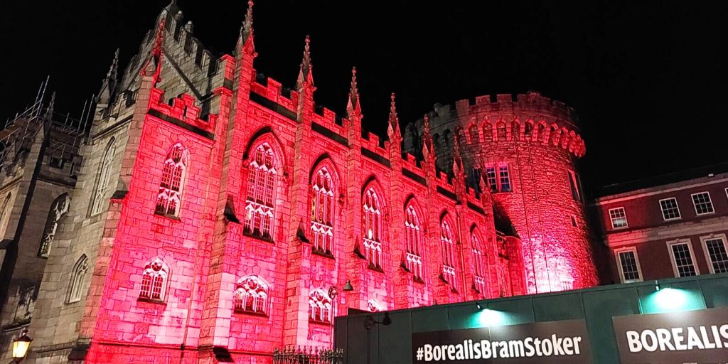 Dublin castle lit up by red light